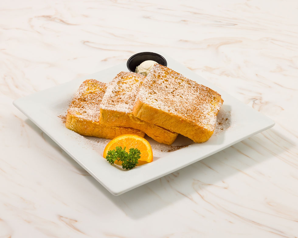 Keke's French Toast with orange spear and butter on plate