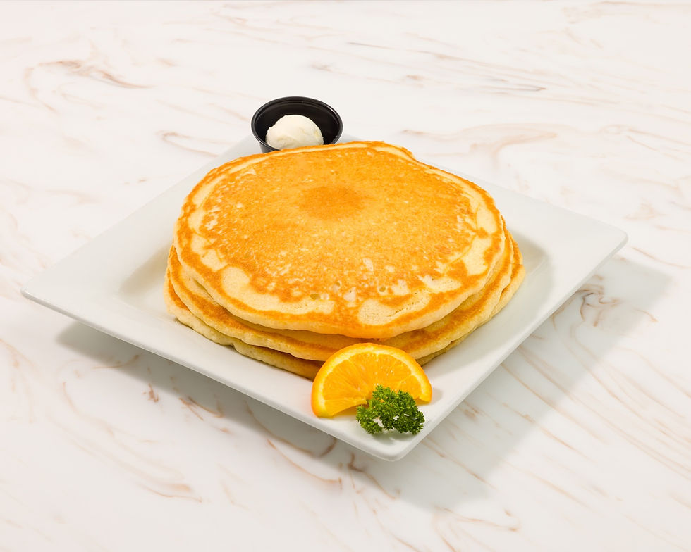 Buttermilk Pancakes with orange slice and butter on plate